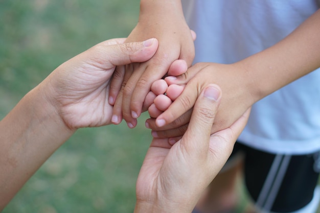 Top view mother's two hands holding son's hand show your son caring mother.