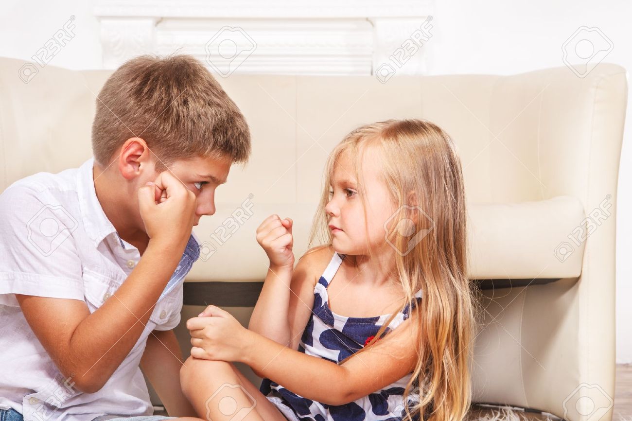 Brother calms angry sister in presence of parents