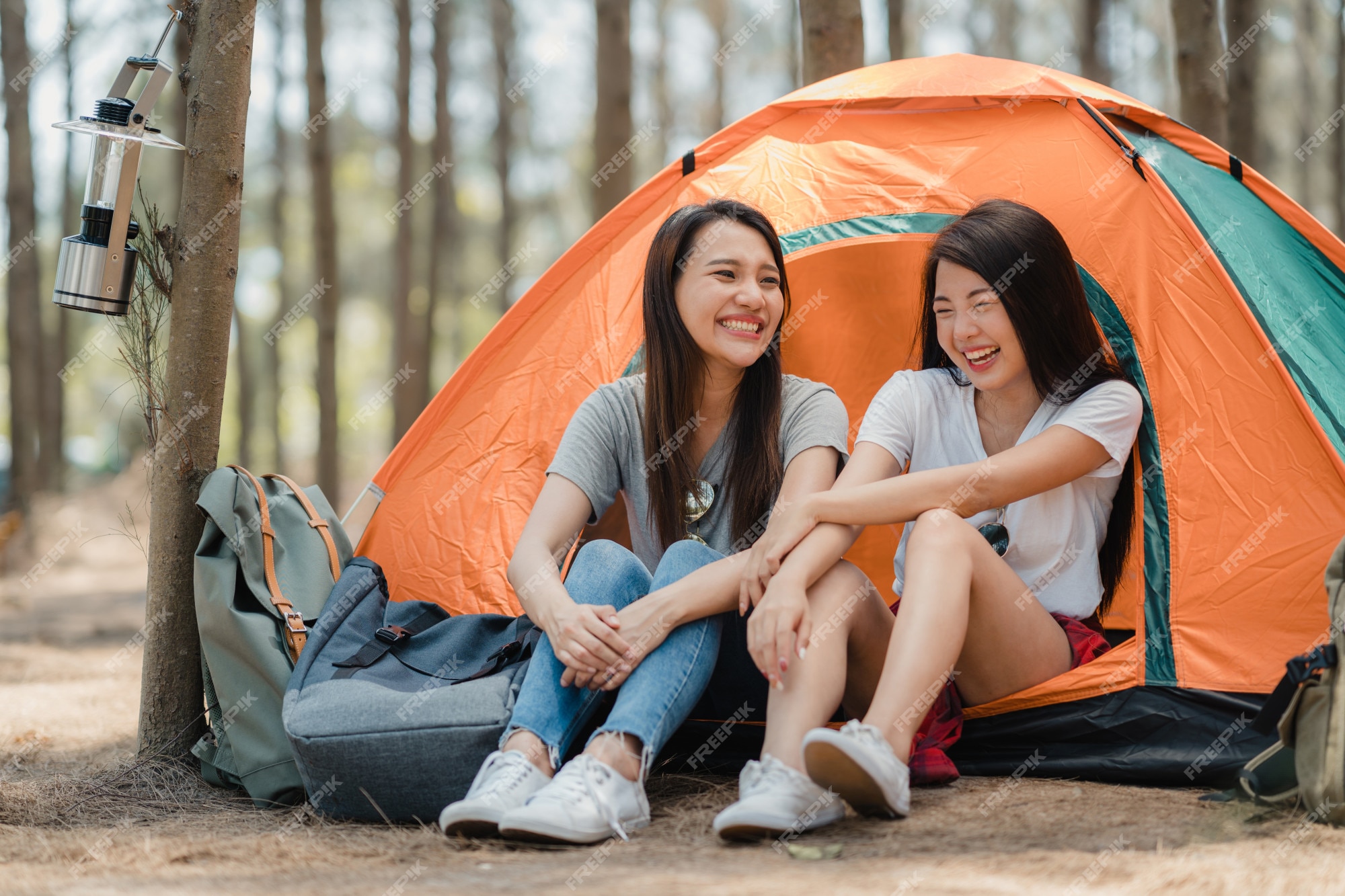 Lesbian couple in a tent. - stock photo